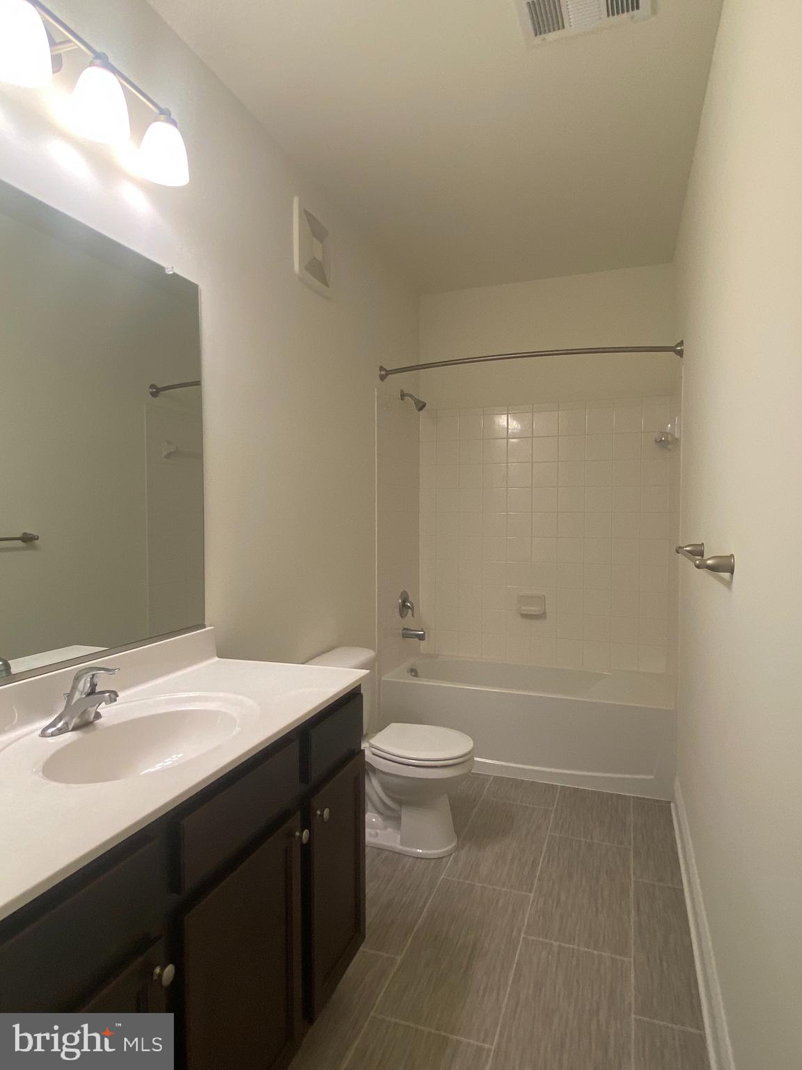 1812 Main Street, Unit 203 Chester, MD 21619 - Photo 17 of 24 a bathroom with a sink a toilet and shower