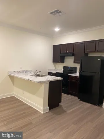 a kitchen with a refrigerator and a stove