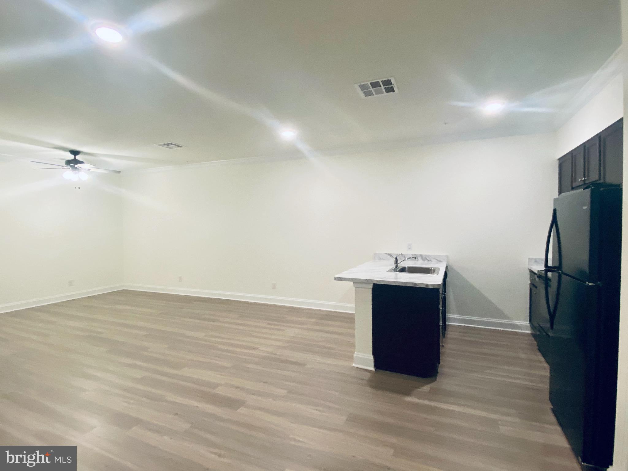 1812 Main Street, Unit 203 Chester, MD 21619 - Photo 24 of 24 a room with wooden floor and window