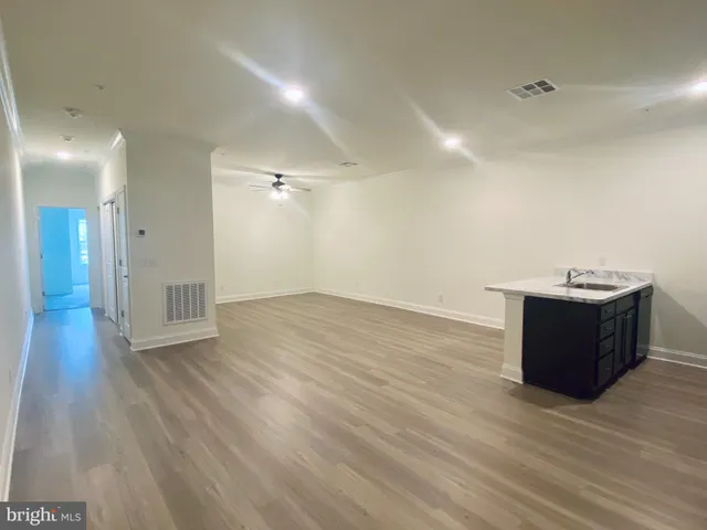 a room with wooden floor and window