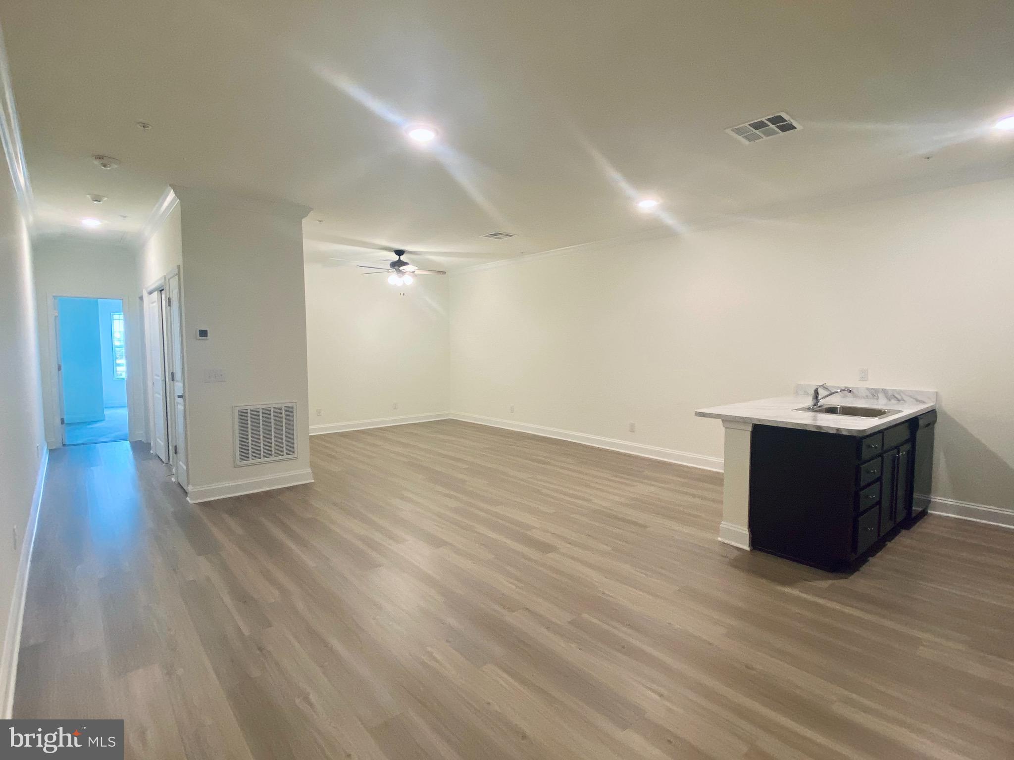 1812 Main Street, Unit 203 Chester, MD 21619 - Photo 5 of 24 a view of a room with wooden floor
