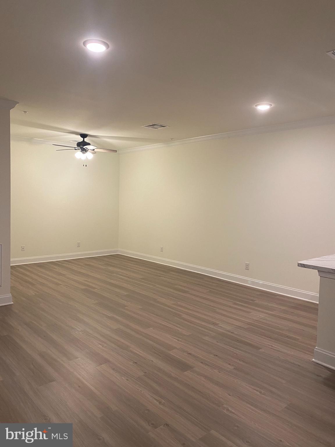 1812 Main Street, Unit 203 Chester, MD 21619 - Photo 9 of 24 wooden floor in an empty room