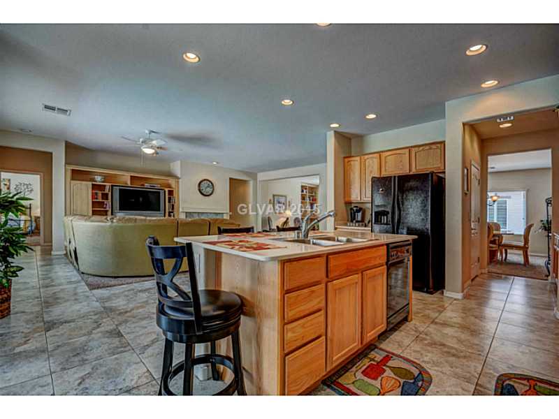 2264 Saxtons River Road Henderson, NV 89044 - Photo 8 of 25 Kitchen. Island/Breakfast Bar, Corian Counters, Tile Floors