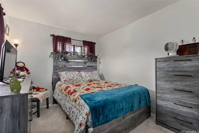 a bedroom with a bed and a dresser in it