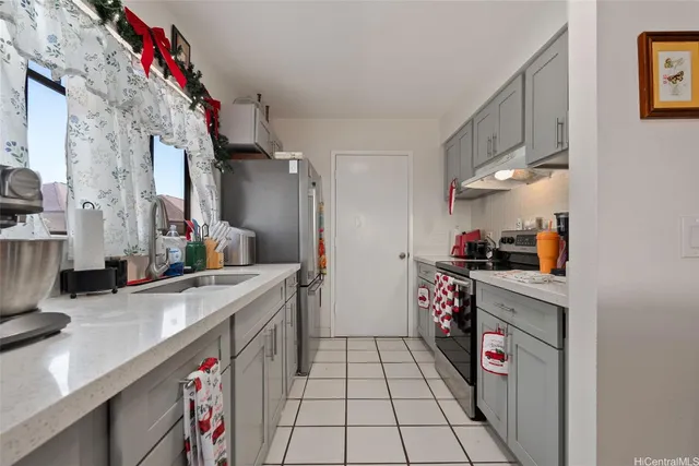 a kitchen with a sink stove and cabinets