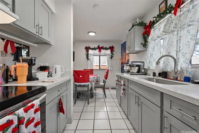 a kitchen with stainless steel appliances granite countertop a sink dishwasher and cabinets with wooden floor