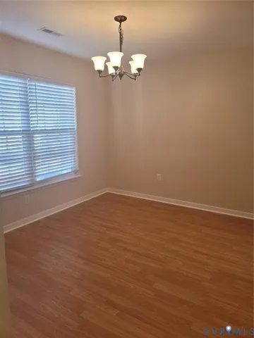 a view of wooden floor and windows in a room