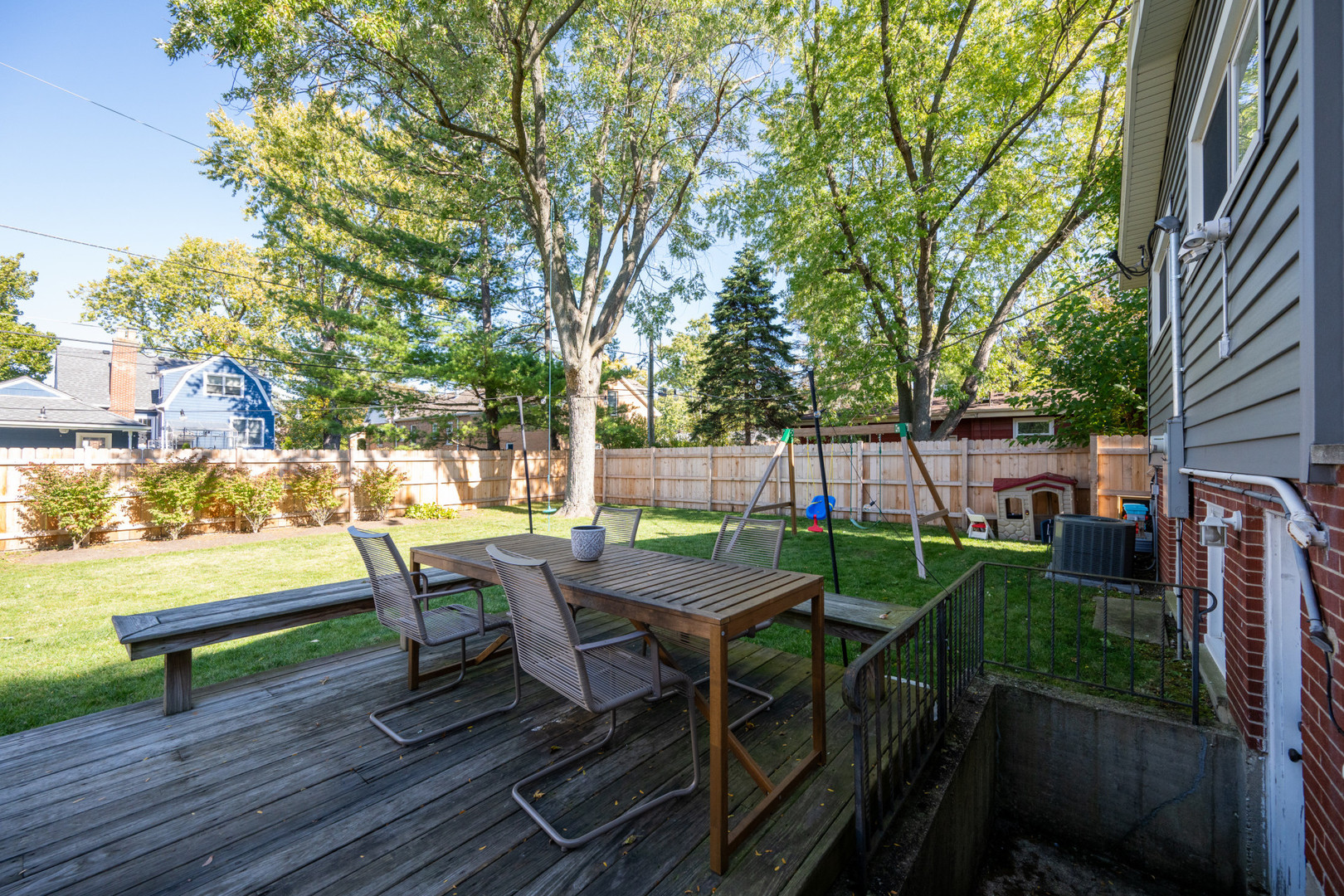 950 Brookside Lane Deerfield, IL 60015 - Photo 6 of 13 a view of a patio with table and chairs and a barbeque with potted plants and large trees