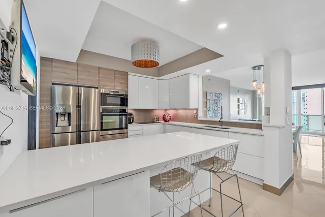 a kitchen with stainless steel appliances a refrigerator and microwave