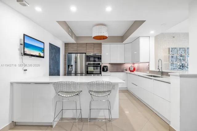 a kitchen with stainless steel appliances granite countertop a sink and cabinets