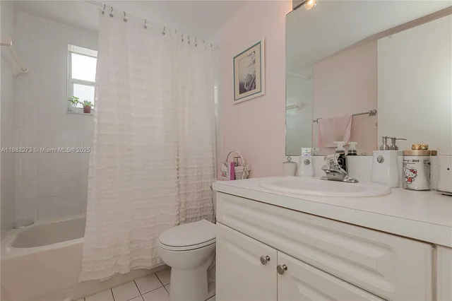 a bedroom with a bed and a television