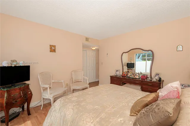 a bedroom with a bed and chair