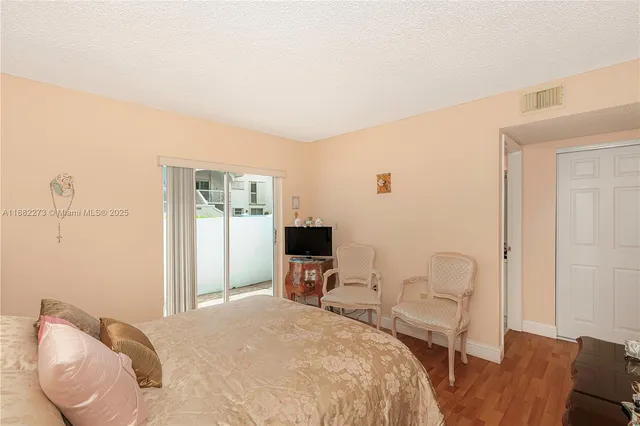 a living room with stainless steel appliances kitchen island granite countertop a sink a stove and a refrigerator