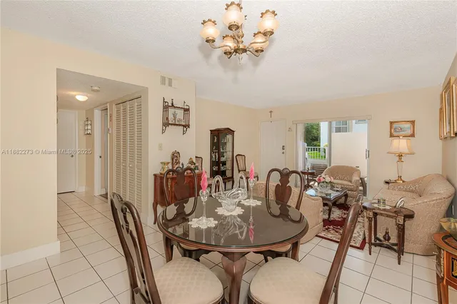 a view of a dining room with furniture and a chandelier