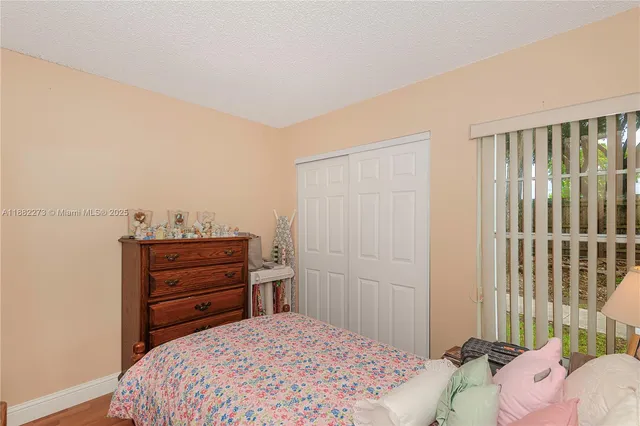 a room with a bed and a dresser