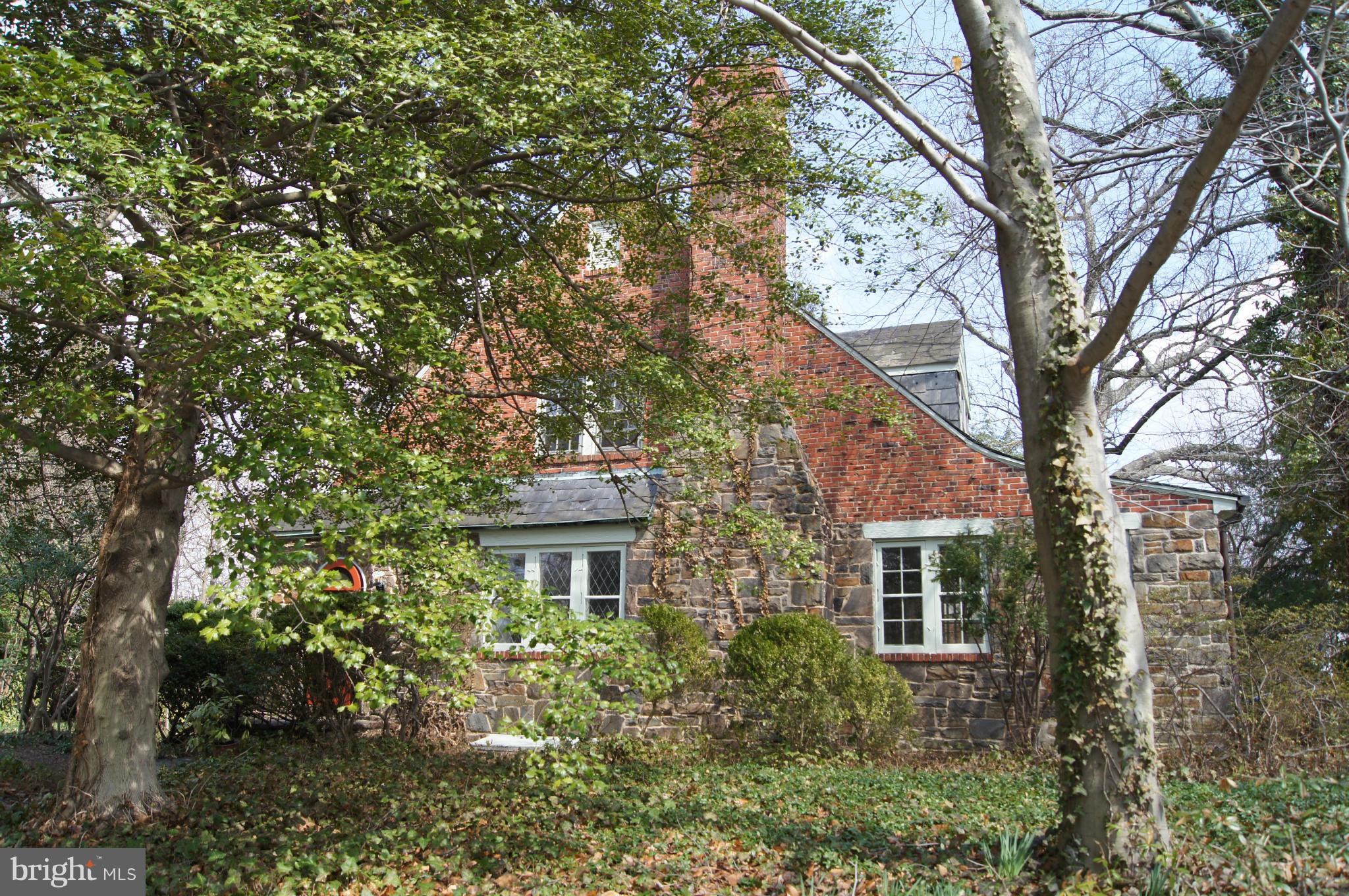 7101 Copeleigh Road Baltimore, MD 21212 - Photo 1 of 30 a front view of a house with a yard and large trees