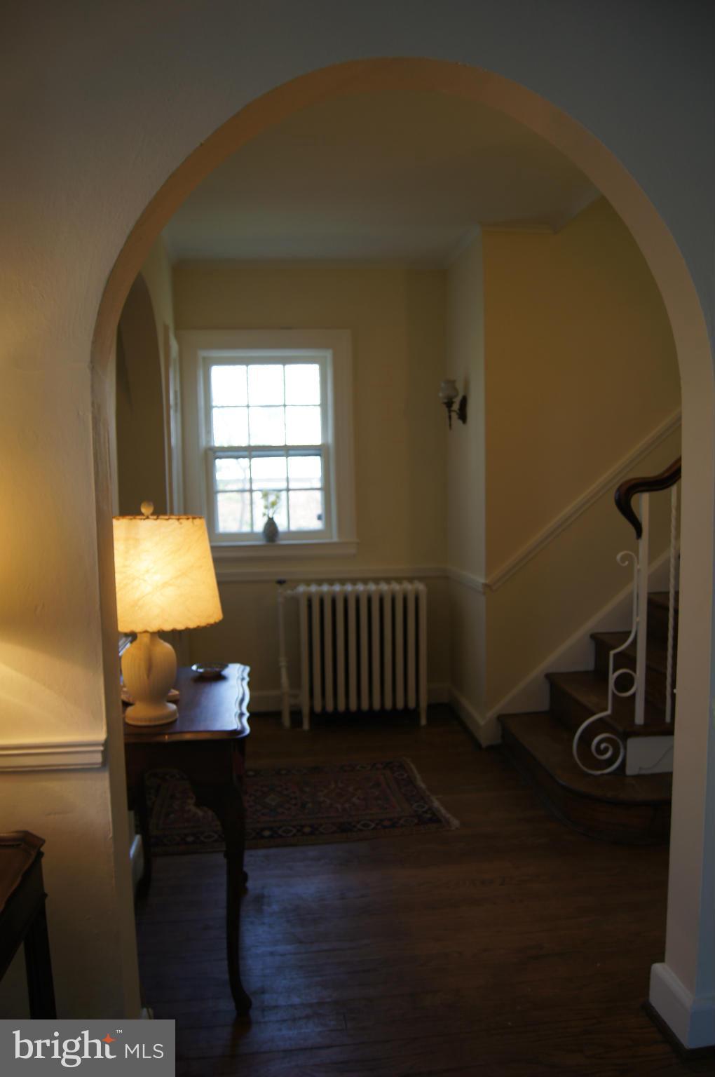 7101 Copeleigh Road Baltimore, MD 21212 - Photo 2 of 30 a bedroom with a bed and wooden floor