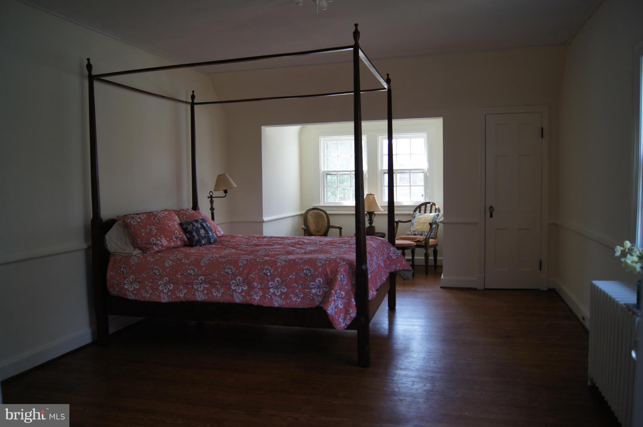 7101 Copeleigh Road Baltimore, MD 21212 - Photo 14 of 30 a spacious bedroom with a bed and wooden floor