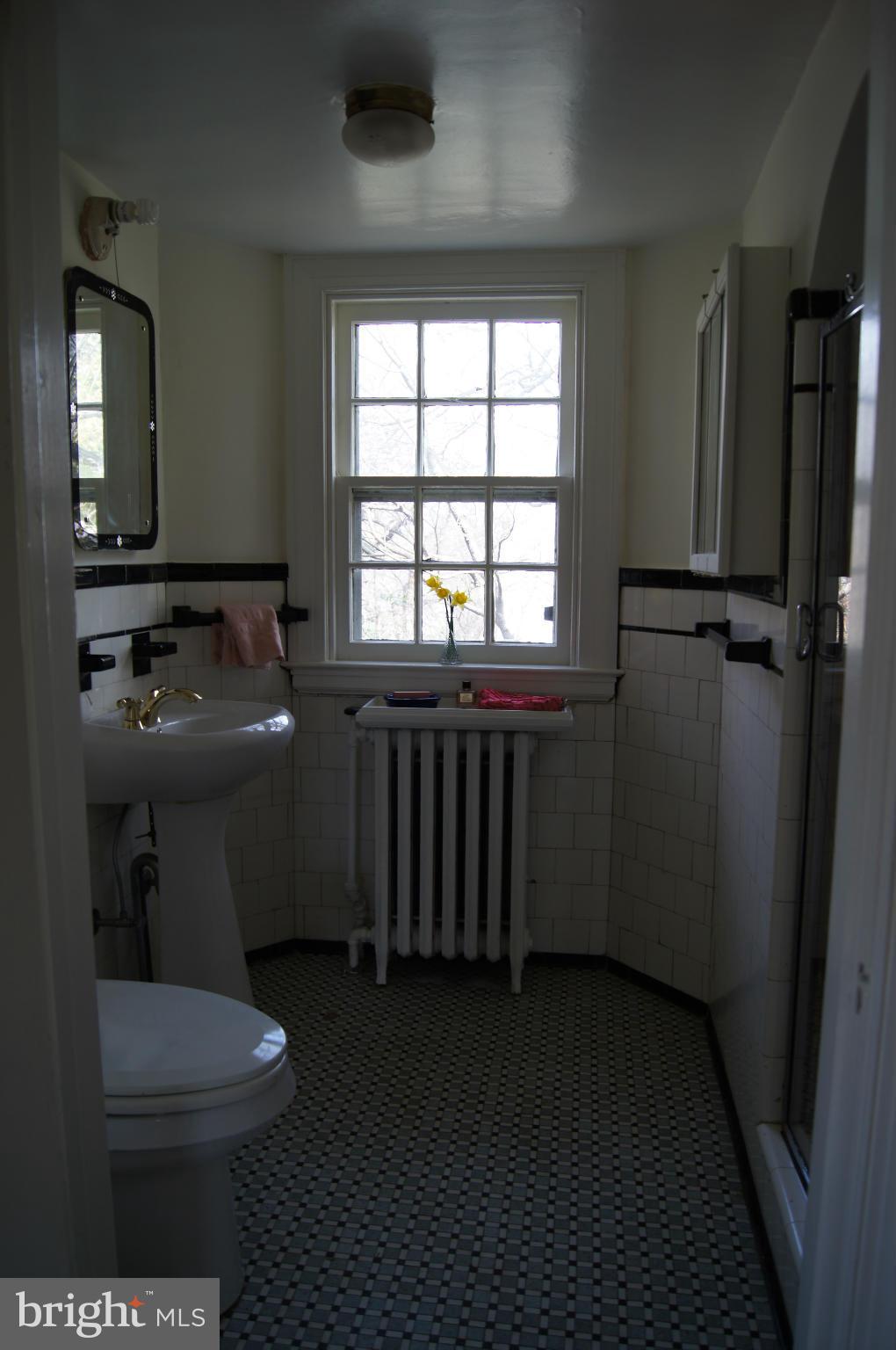 7101 Copeleigh Road Baltimore, MD 21212 - Photo 15 of 30 a bathroom with a toilet a sink and a mirror