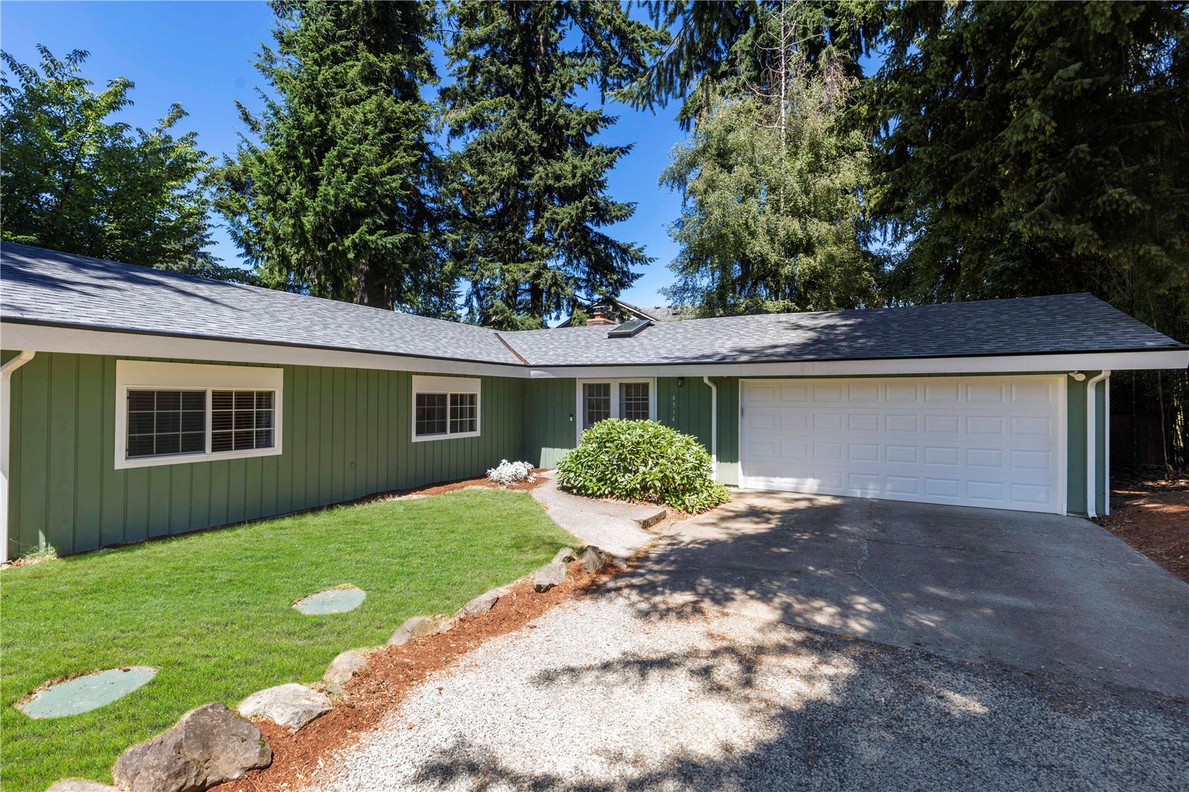 4514 Northeast 17th Place Renton, WA 98059 - Photo 32 of 39 a front view of a house with a garden and yard