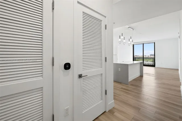 a view of a room with wooden floor and a window
