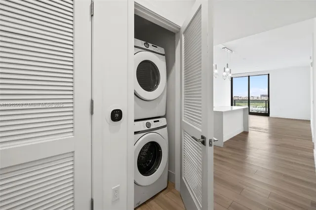 a view of a room with wooden floor and cabinet