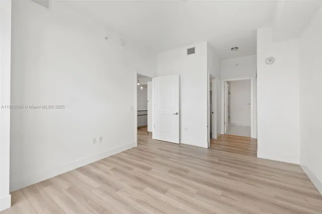 a bathroom with a granite countertop sink a toilet and a mirror