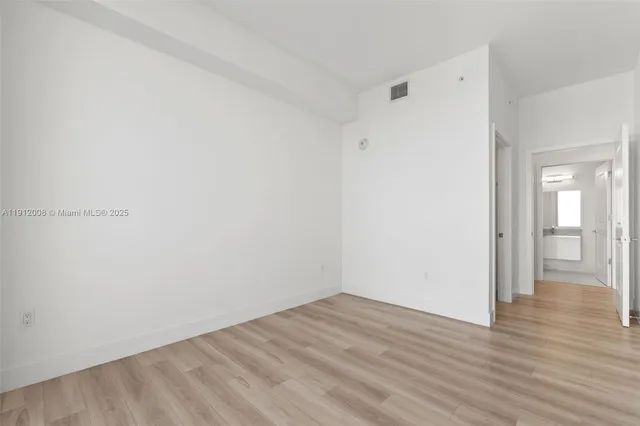 a bedroom with furniture and a large window