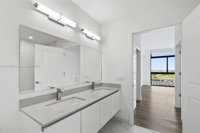 a living room with furniture and large windows