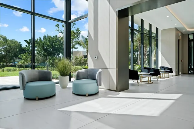 a living room with furniture and a floor to ceiling window