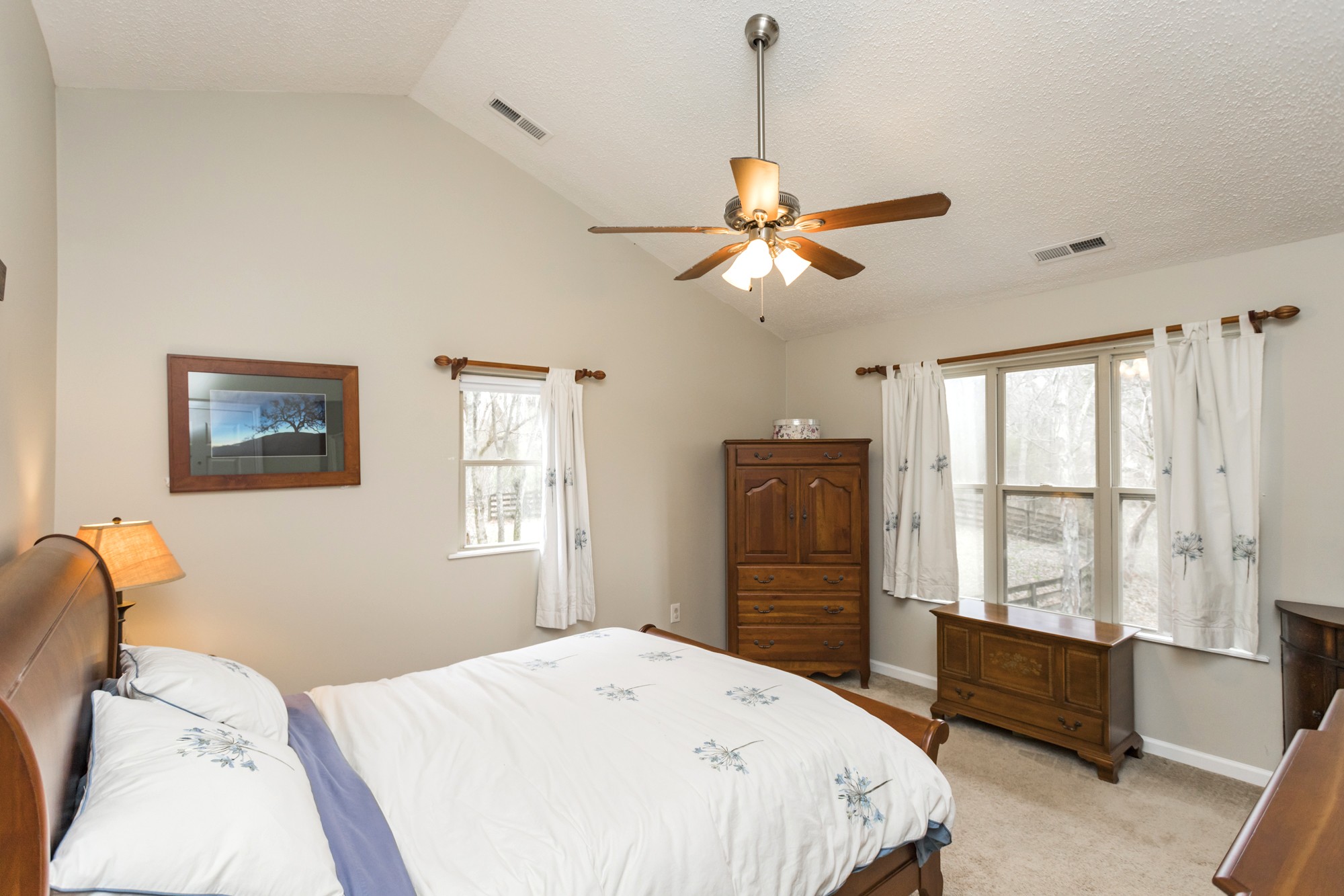 4306 Kedron Road Spring Hill, TN 37174 - Photo 17 of 35 a bedroom with a bed and a chandelier