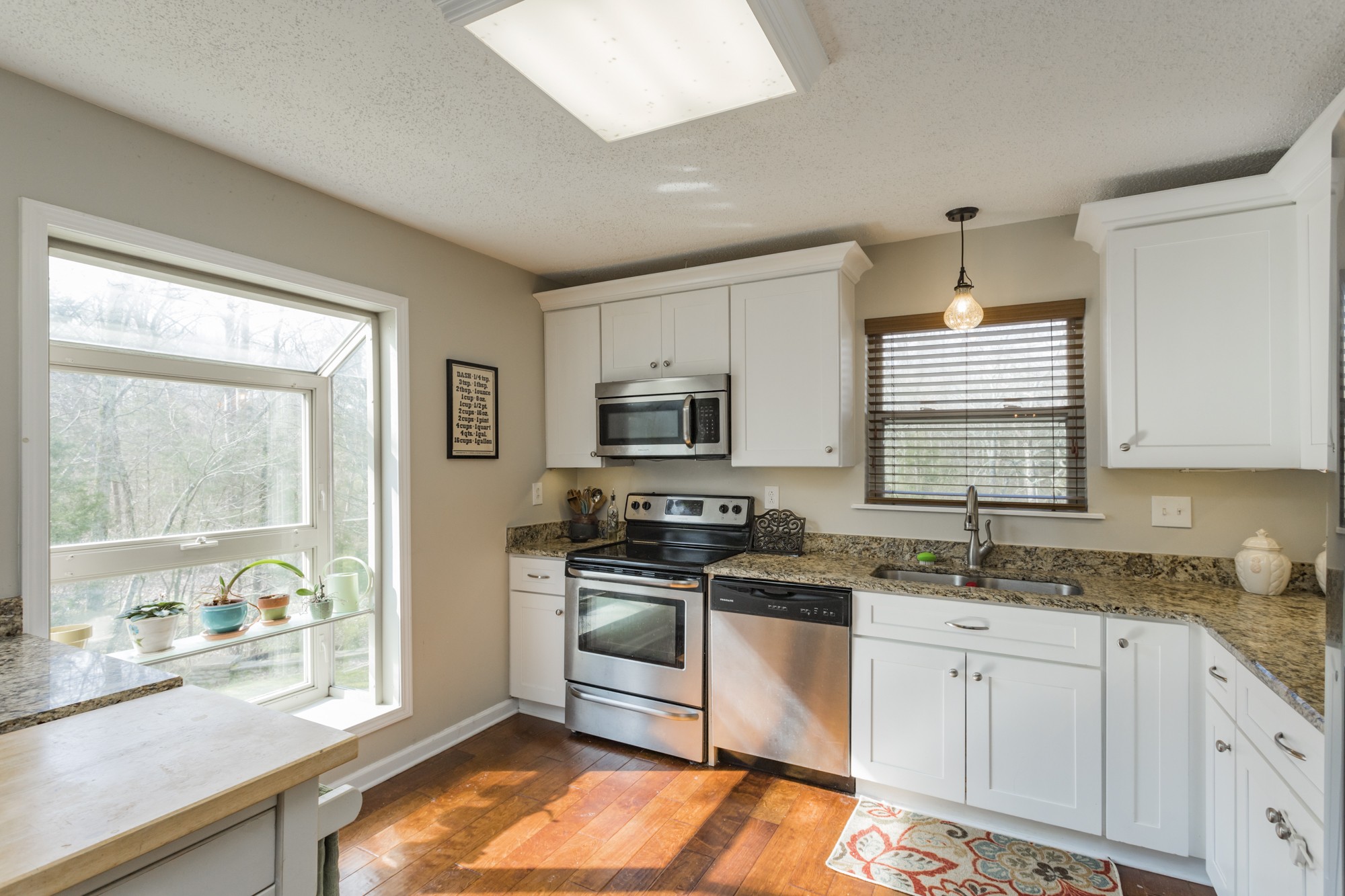 4306 Kedron Road Spring Hill, TN 37174 - Photo 6 of 35 a kitchen with stainless steel appliances granite countertop a stove a sink and a microwave