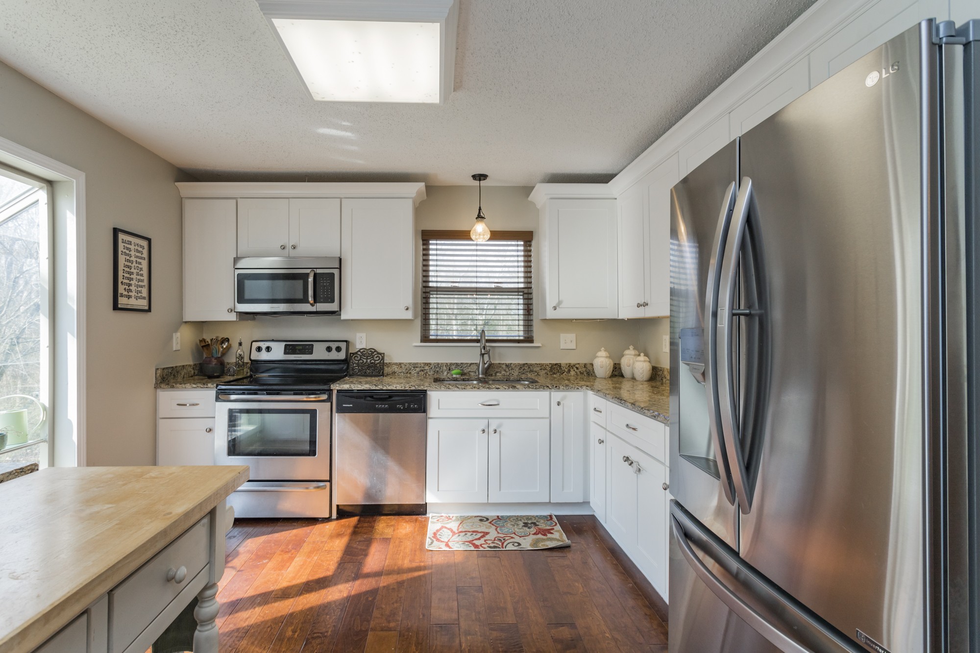4306 Kedron Road Spring Hill, TN 37174 - Photo 7 of 35 a kitchen with stainless steel appliances granite countertop a refrigerator stove microwave and sink