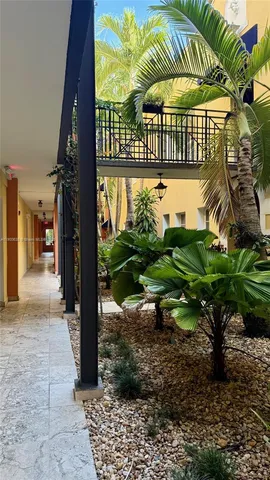 a living room with furniture chandelier and a flat screen tv