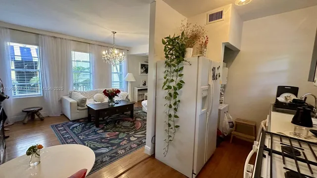 a bedroom with two beds and a chandelier