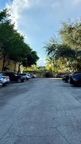 a front view of a house with a yard and fountain in middle of the house