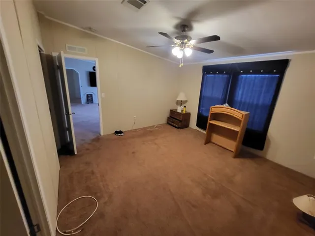 a view of an empty room with a mirror