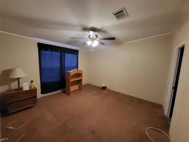 a living room with furniture and a ceiling fan