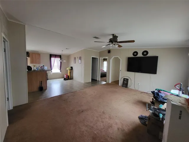 a view of a livingroom with furniture and a ceiling fan