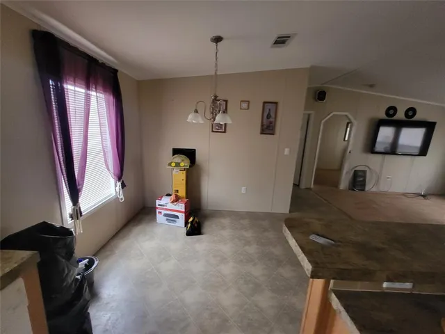 a view of hall way with furniture and gym equipment