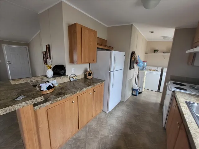 a kitchen with refrigerator and sink