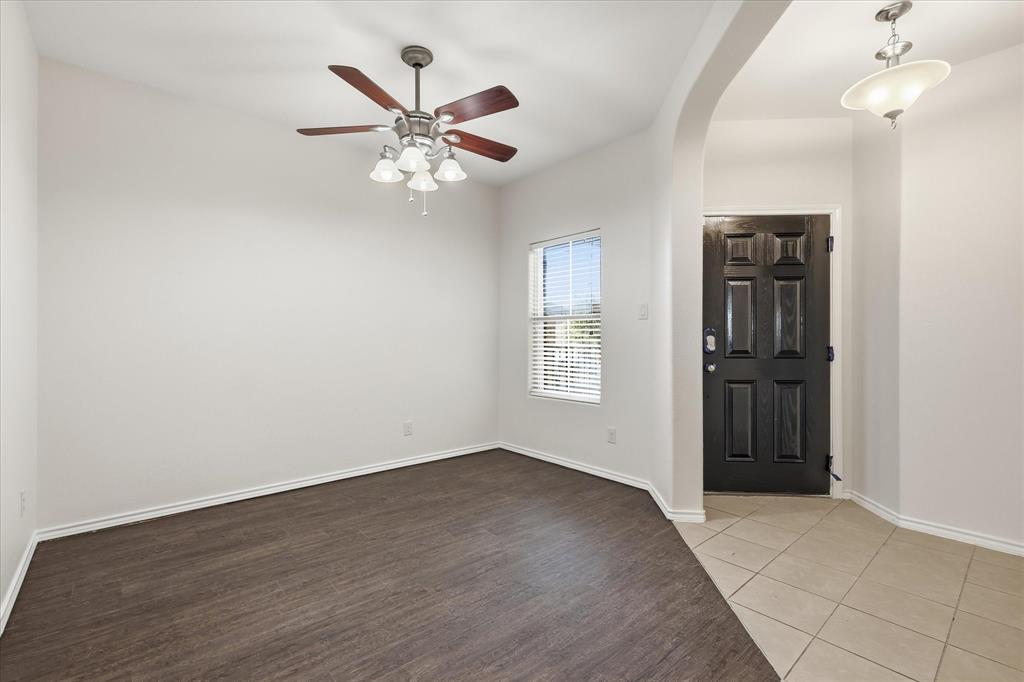 720 Rio Bravo Drive Fort Worth, TX 76052 - Photo 6 of 38 Entryway featuring a dark paneled door and light tile flooring
