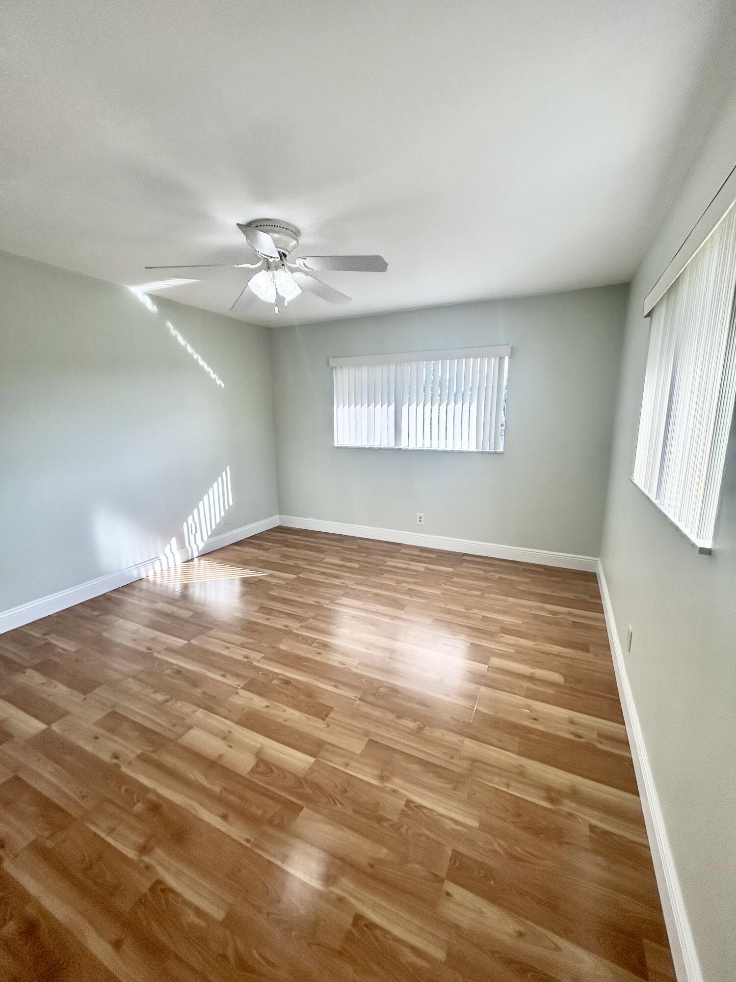 9855 Sandalfoot Boulevard, Unit 320 Boca Raton, FL 33428 - Photo 15 of 23 wooden floor in an empty room with a window