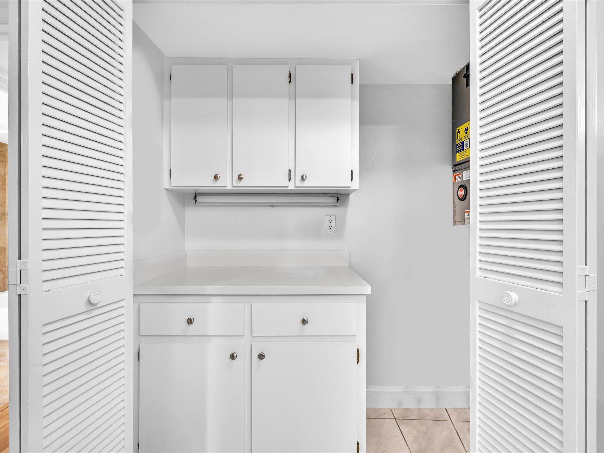 9855 Sandalfoot Boulevard, Unit 320 Boca Raton, FL 33428 - Photo 4 of 23 a view of kitchen with white cabinets