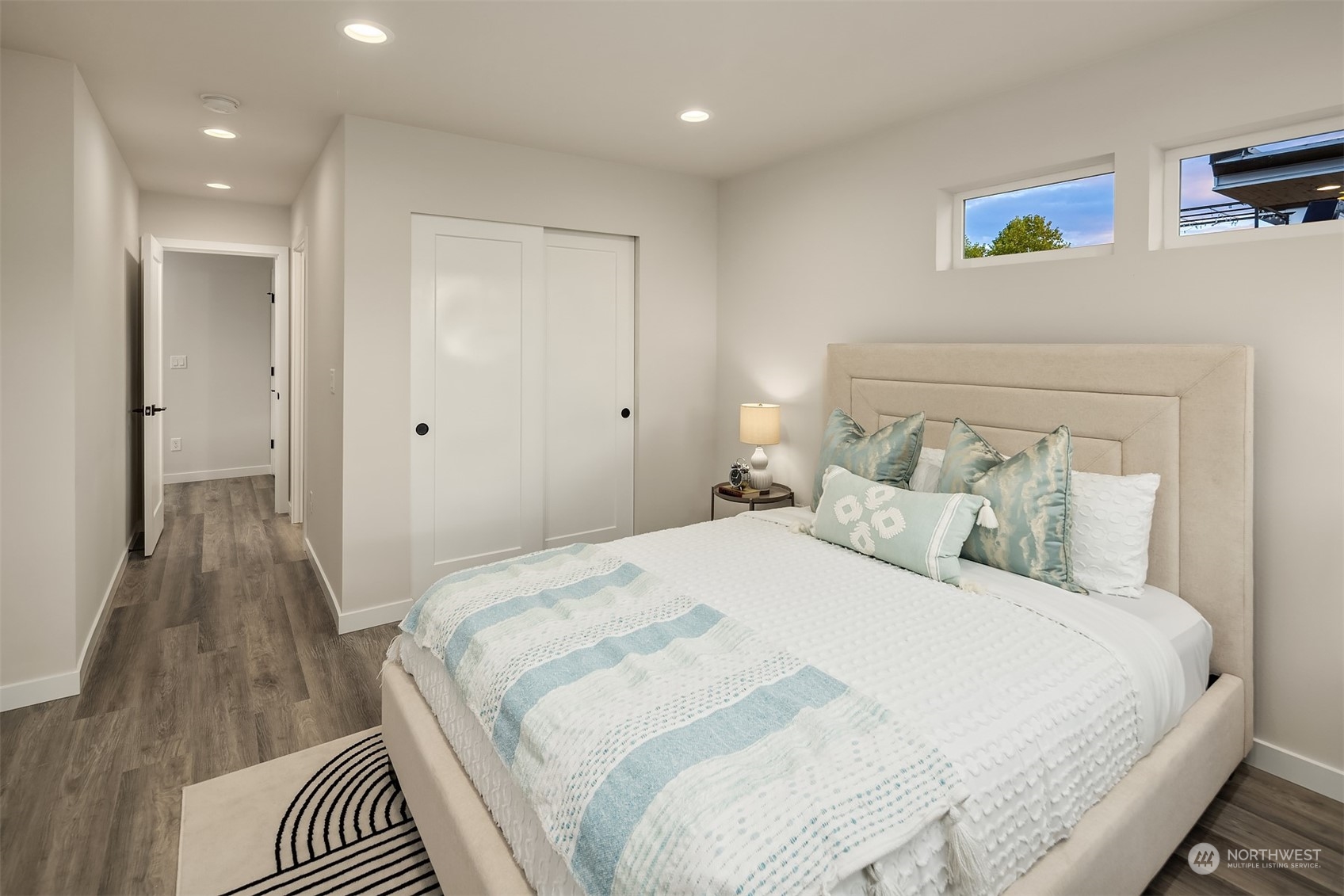 1112 21st Avenue South, Unit A Seattle, WA 98144 - Photo 13 of 27 a bedroom with a bed and a walk in closet