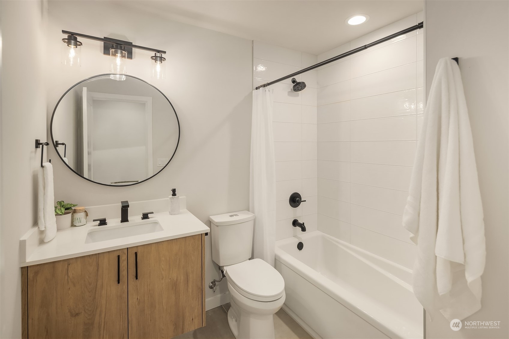 1112 21st Avenue South, Unit A Seattle, WA 98144 - Photo 17 of 27 a bathroom with a sink toilet and a mirror