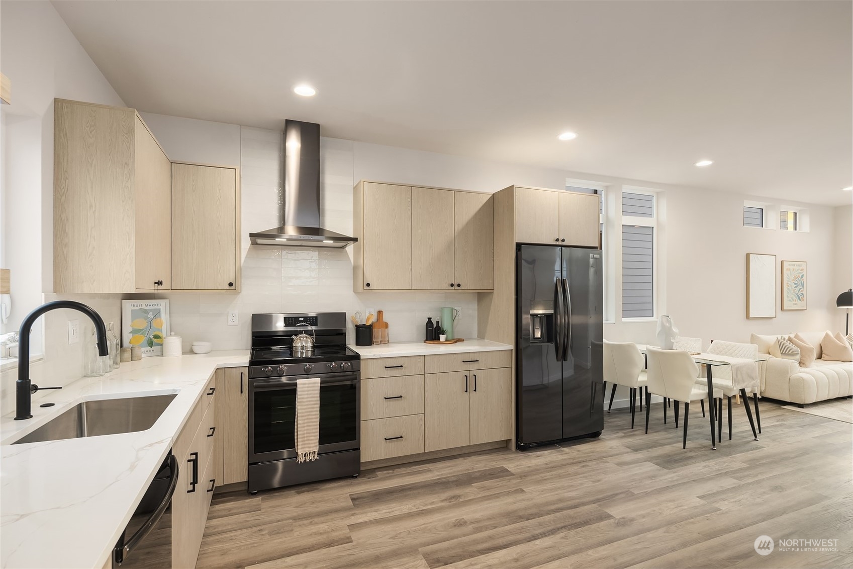 1112 21st Avenue South, Unit A Seattle, WA 98144 - Photo 3 of 27 a kitchen with white cabinets and stainless steel appliances