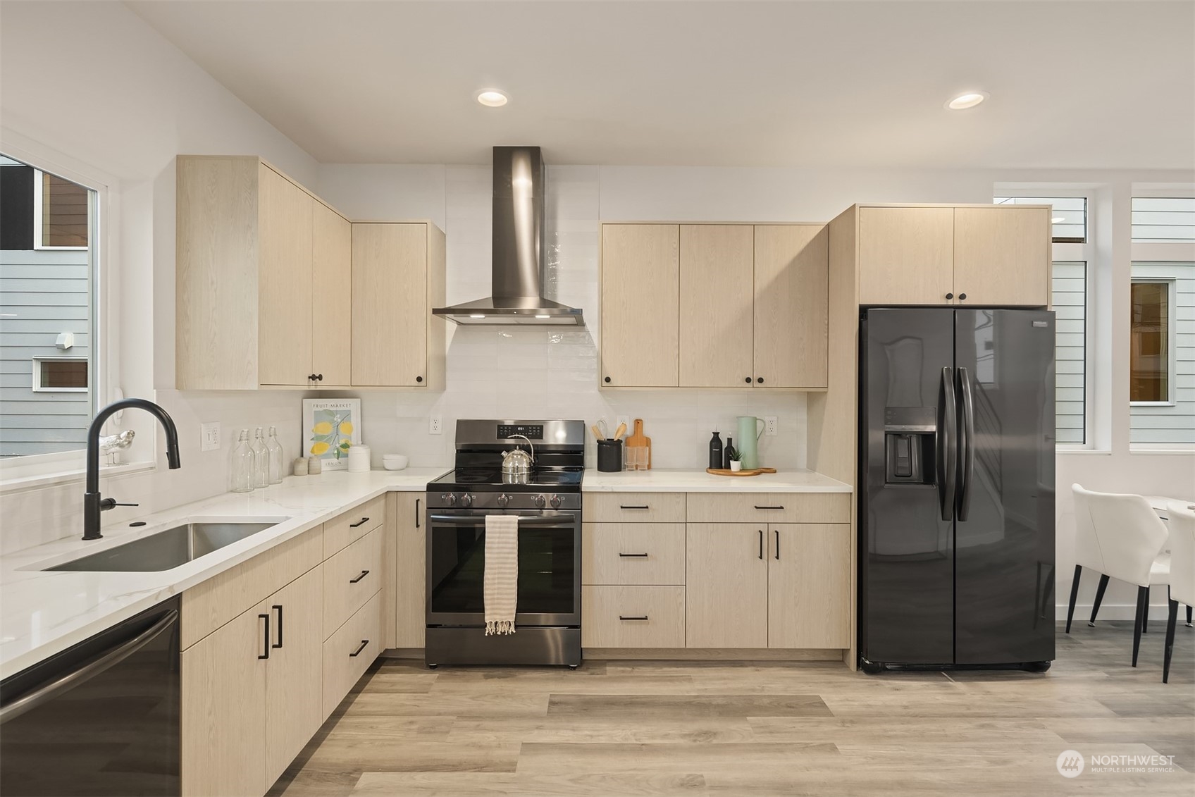 1112 21st Avenue South, Unit A Seattle, WA 98144 - Photo 4 of 27 a kitchen with stainless steel appliances granite countertop a refrigerator sink and white cabinets
