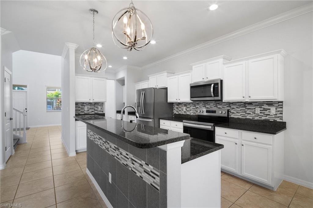21620 Bella Terra Boulevard Estero, FL 33928 - Photo 6 of 37 a kitchen with a sink a counter space appliances and cabinets