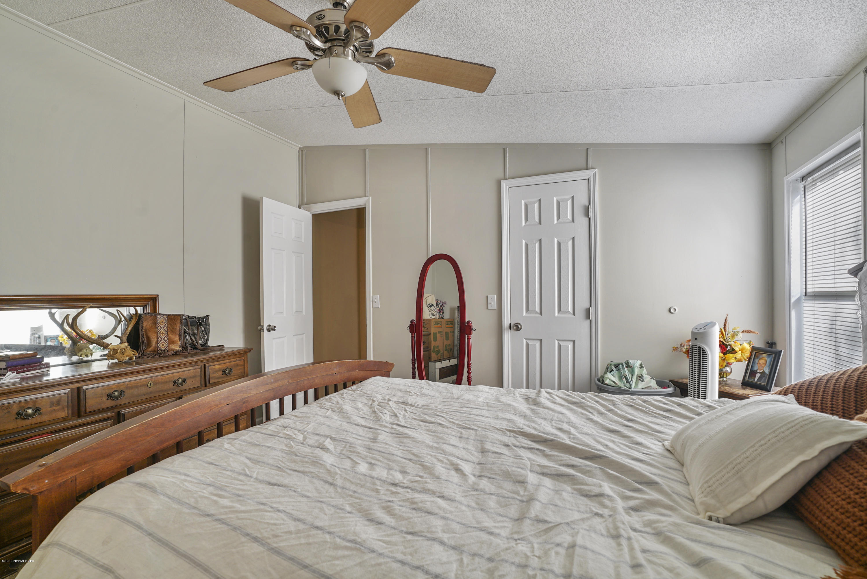 1435 Long Bay Road Middleburg, FL 32068 - Photo 16 of 27 a bedroom with a bed and a dresser
